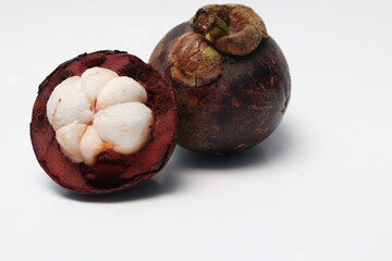 
Fresh ripe mangosteen fruit, white on the inside and brown or purple on the outside. The taste is sweet and refreshing. Isolated white background.