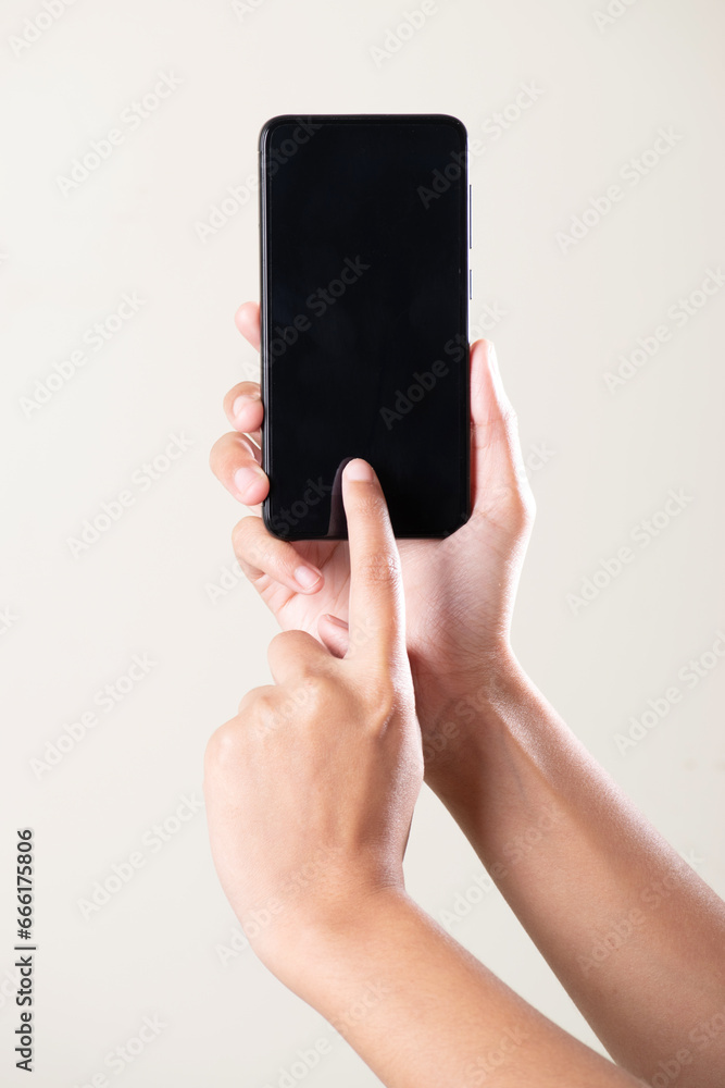 Wall mural Black screen phone in hand using with finger on grey background