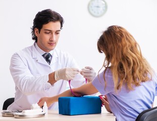 Female patient during blood test sampling procedure