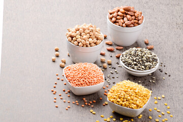 Assorted uncooked gram and lentils on table