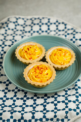 Lemon Tart muffin cup cake served in plate isolated on napkin side view of cafe baked food on background