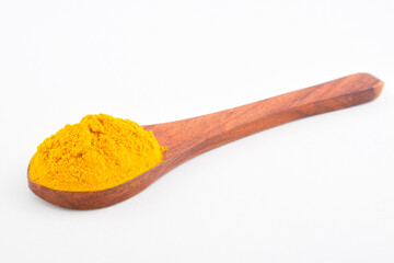Turmeric powder in wooden spoon isolated on white background with clipping path