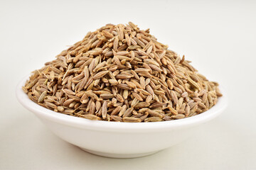 Jeera in bowl on white background