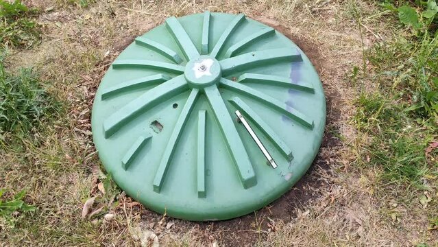 Plastic sewer cover in the yard. Construction of a septic tank.