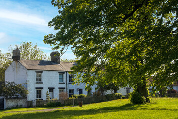 Obraz premium beautiful stone built houses on village green.