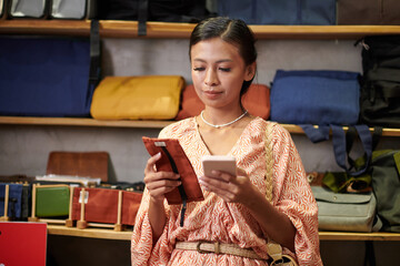 Young woman thinking of she needs new textile smartphone case