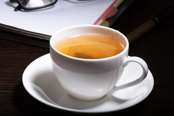 Closeup of green cup of tea at table