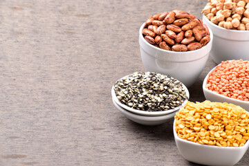Raw legumes and pulses in bowl, variety of uncooked beans