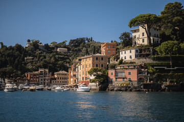Fototapeta na wymiar Famous place on the Italian Riviera coast - views of Portofino from the sea and cliffs