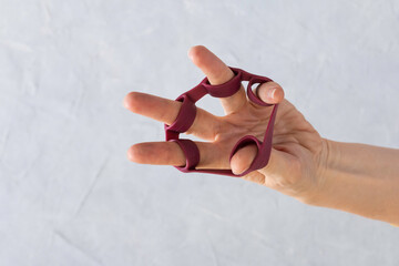 Hand grip strengthener in woman hand.