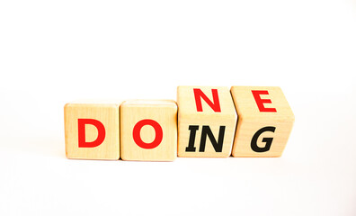 Doing and done symbol. Concept words Doing Done on wooden block. Beautiful white table white background. Business doing and done concept. Copy space. © Dzmitry