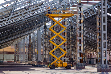 Metal frame high rise construction with diesel scissor lift