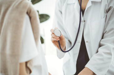 Doctor and a kid patient. Physician is holding stethoscope and ready to examine boy. Perfect health concept in medicine