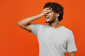 Young sad upset shocked Indian man he wears t-shirt casual clothes put hand on face facepalm epic fail mistaken omg gesture isolated on orange red color background studio portrait. Lifestyle concept. - obrazy, fototapety, plakaty