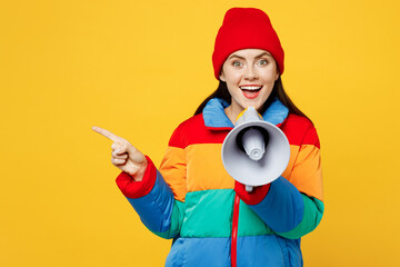Young surprised woman she wears padded windbreaker jacket red hat casual clothes hold in hand...