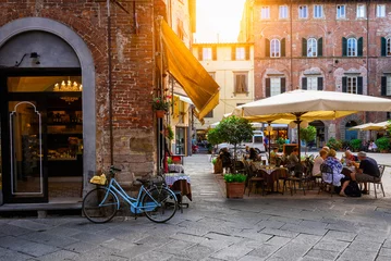 Poster Im Rahmen Old cozy street with tables of restaurant in Lucca, Italy © Ekaterina Belova