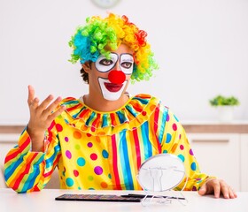 Male clown preparing for perfomance at home