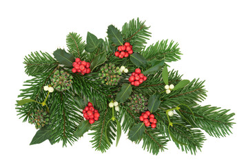 Christmas winter greenery floral decoration with holly berries, spruce fir, mistletoe, ivy, on white background, Festive green greeting card design for New Year, Yule, Noel.
