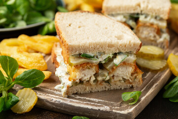 Fish Finger Sandwich on wooden board with potato fries