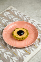 Blueberry Cheese Tart served in plate isolated on napkin side view of cafe baked food on background