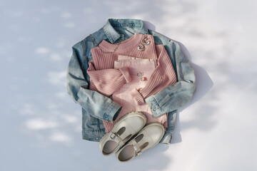 Denim jacket with jeans and pink sweater on white background. Women's jumper stylish autumn or...