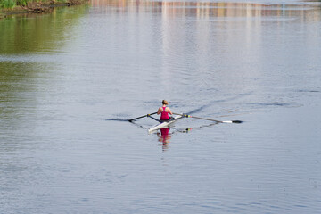 Women training on canoe to practise rowing during early morning on river