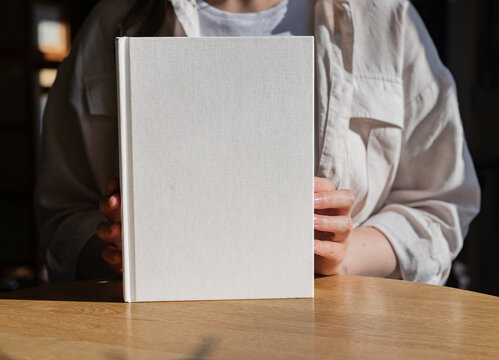 Hands showing, recommending book in hard cover mockup