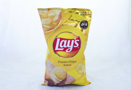 Johannesburg, South Africa - a bag of salted Lays potato chips isolated on a clear background with copy space