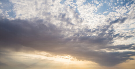 Minimalistic evening sky with clouds and sun glare, looking up at the sky in the evening