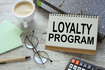 Loyalty Program . open notepad with text on document folder