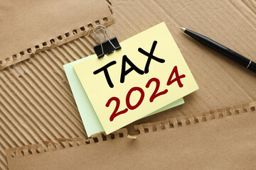 tax 2024. . Business concept top view on bright note paper. words Concept text