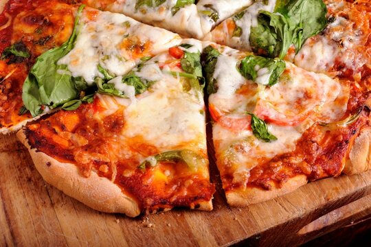 4K Image: Close-Up of Delectable Pizza with Fresh Basil Leaves