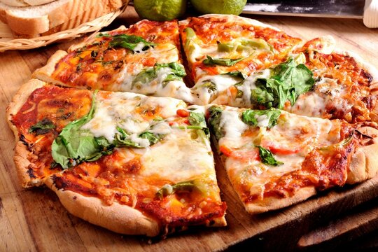 4K Image: Close-Up of Delectable Pizza with Fresh Basil Leaves
