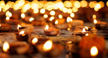 Diwali, Hindu festival of lights celebration. Clay diya candles illuminated in Dipavali, Traditional oil lamps on dark background