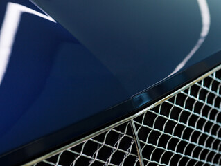 Modern luxury blue car close-up of grille. Concept of expensive, sports auto detailing
