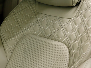 Close up of a premium electric car interior with light milky high-tech comfortable seats. Interior...