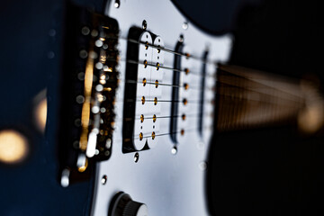 Blue electric guitar with stage light reflections