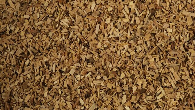 Splinter sliver for food smoking on the grill made of fruit pear wood. Wood chips for barbecue, close-up. Video 4K, clockwise Rotation. Pearwood chips.