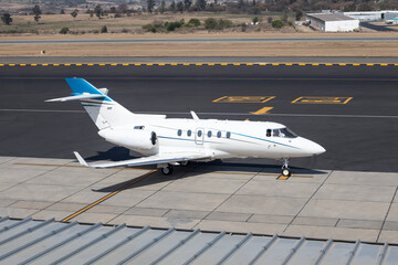 Side view of luxury airplane for private flights stationary on airport runway