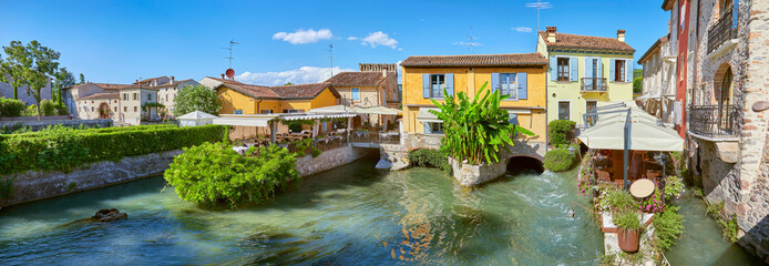 Beautiful impressions in the mill village of Borghetto on the river Minico, in the south of Lake Garda, in Veneto, Italy. - obrazy, fototapety, plakaty