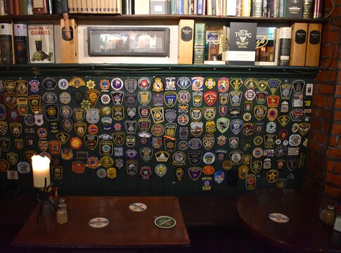 Police patches on the wall of The Brazen Head pub, October 2019 Dublin