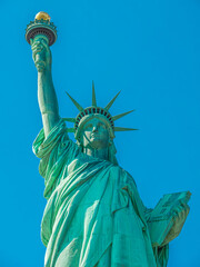 statue of liberty in new york city on a sunny day, blue sky