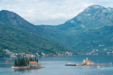 Aerial view of the Perast Islands of St. George and Our Lady of the Rocks and the mountains in the background. Perast, Boka Bay, Montenegro 