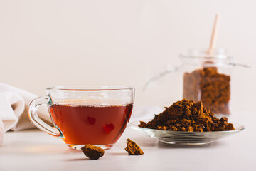 Chaga therapeutic tea from birch mushroom in a cup on the table