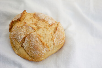 Warm bread on a white cloth.