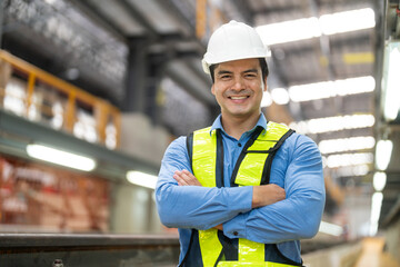 Portrait of apprentice under train in railway engineering facility