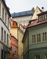 A historical colorful street of Lesser Town with a view of Schwarzenberg Palace, Prague, the Czech Republic