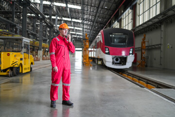 Portrait of engineer and apprentice in workshop of railway engineering facility