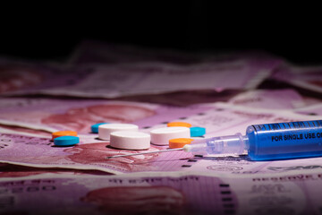 Medicine with indian currency, high cost treatment concept