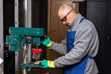 Working on vertical drilling machines in the industrial plant for producing new items